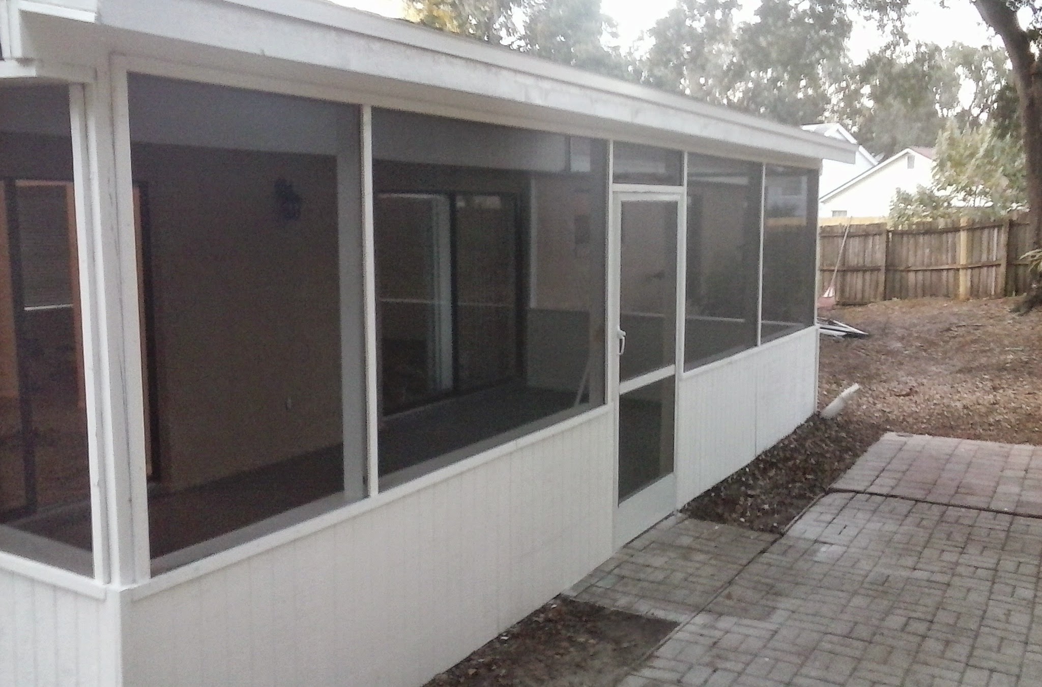 Finished screen patio enclosure with clean white panels and trim